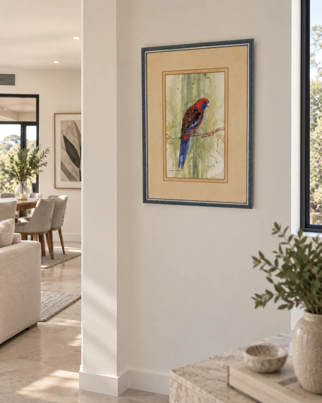 Framed bird artwork installed on a wall near a window