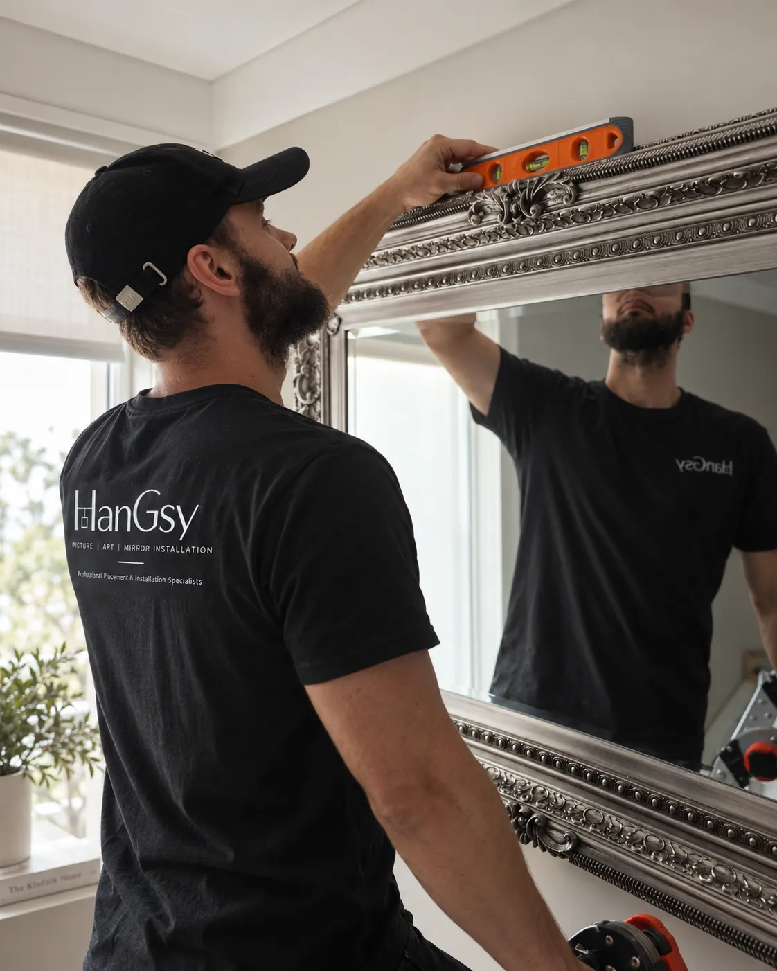 HanGsy installer levelling an ornate silver-framed mirror