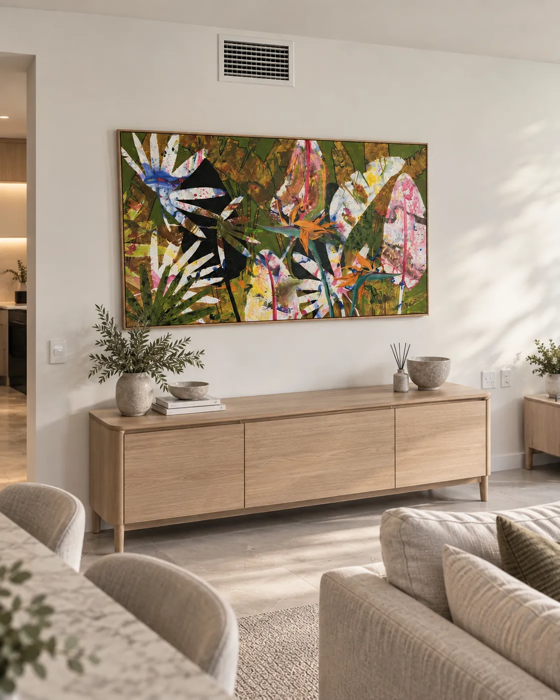 Large framed canvas installed above a timber sideboard in a living room