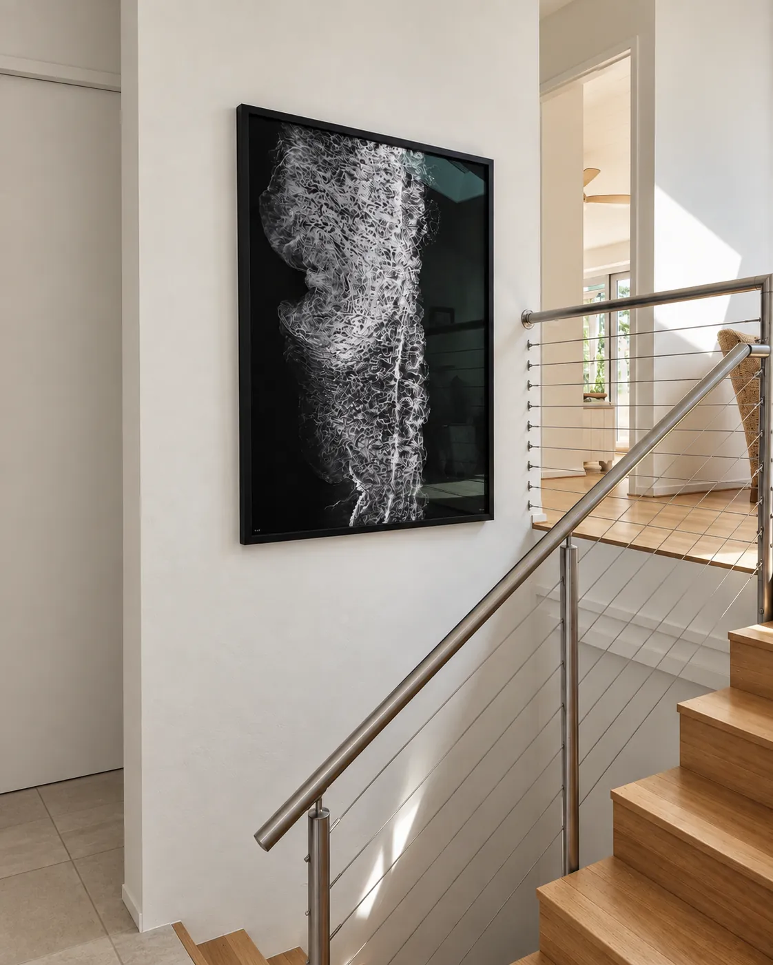 Black-framed artwork installed on a stairwell wall