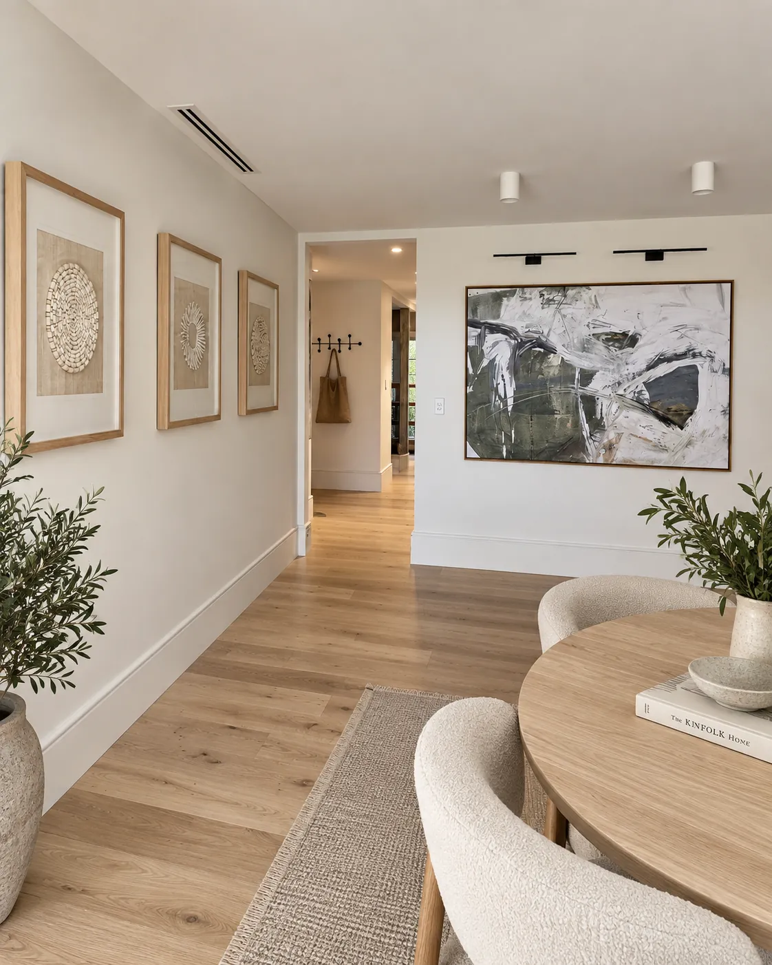 Three matching framed works installed along a hallway