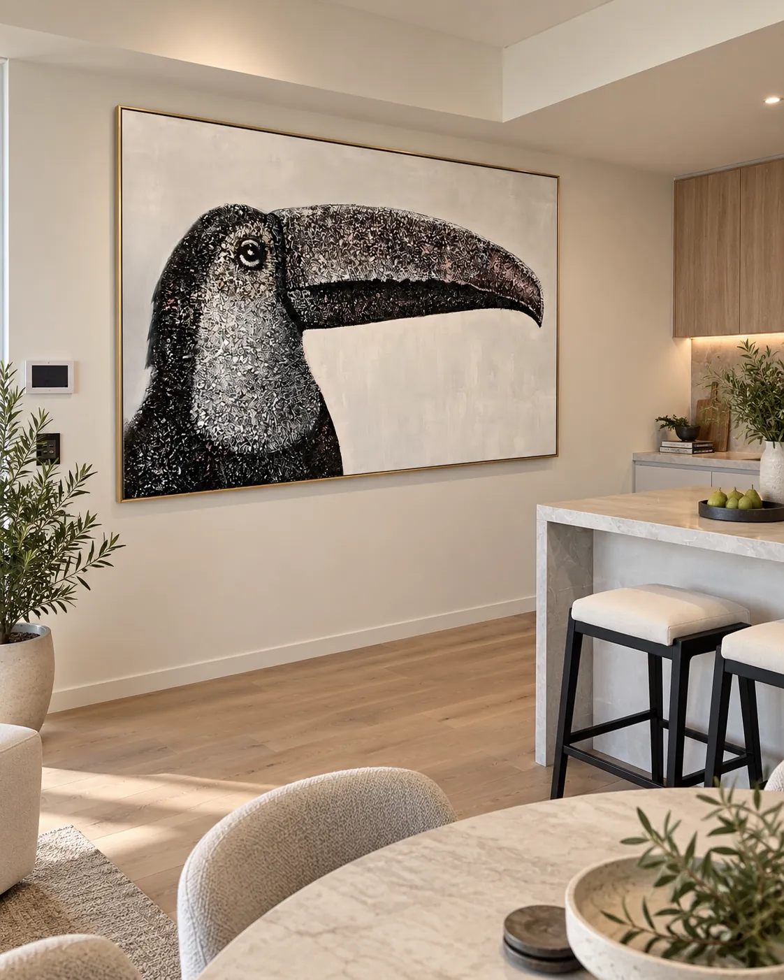 Large gold-framed toucan artwork installed above a kitchen island
